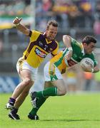 4 July 2009; Thomas Deehan, Offaly, in action against Damien Carter, Wexford. GAA All-Ireland Senior Football Championship Qualifier, Round 1, Wexford v Offaly, Wexford Park, Wexford. Picture credit: Ray McManus / SPORTSFILE