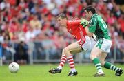 5 July 2009; Ger Collins, Limerick, is held back by Ray Carey, Cork. GAA Football Munster Senior Championship Final, Limerick v Cork, Pairc Ui Chaoimh, Cork. Picture credit: Brendan Moran / SPORTSFILE