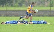 4 July 2009; Waterford's Mary Foley, left, and Michelle Ryan lie flat on the pitch after clashing heads as Clare's Rachel Lenihan comes away with possession for her team. TG4 Ladies Football Munster Intermediate Championship Final, Clare v Waterford, Bruff, Co. Limerick. Picture credit: Diarmuid Greene / SPORTSFILE