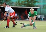 9July 2009; Michael Watt, Ireland, scores his side's first goal despite the challenge of Tomasz Dutkiewicz, Poland. FIH Champions Challenge II, Ireland v Poland, National Hockey Stadium, UCD, Belfield, Dublin. Picture credit: Brendan Moran / SPORTSFILE