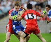 11 July 2009; Dermot McAdle, Monaghan, in action against Fergal Doherty and Eoin Bradley, Derry. GAA Football All-Ireland Senior Championship Qualifier, Round 2, Monaghan v Derry, St Tighearnach's Park, Clones, Co. Monaghan. Picture credit: Oliver McVeigh / SPORTSFILE
