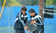 18 July 2009; Real Madrid's Cristiano Ronaldo, right, and team-mate Raul lift a weight during heavy rain at squad training. Real Madrid pre-season squad training, Carton House, Maynooth, Co. Kildare. Picture credit: David Maher / SPORTSFILE
