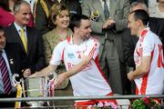 19 July 2009; Tyrone's Ryan McMenamin shares a joke with team-mate and captain Brian Dooher as President of Ireland Mary McAleese and her husband Dr. Martin McAleese look on. GAA Football Ulster Senior Championship Final, Tyrone v Antrim, St Tighearnach's Park, Clones, Co. Monaghan. Picture credit: Brian Lawless / SPORTSFILE