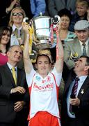 19 July 2009; Tyrone captain Brian Dooher lifts the cup as Dr. Martin McAleese, left, and Ulster GAA President Tom Daly keep a check on the lid. GAA Football Ulster Senior Championship Final, Tyrone v Antrim, St Tighearnach's Park, Clones, Co. Monaghan. Picture credit: Brian Lawless / SPORTSFILE