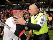 19 July 2009; Tyrone manager, Mickey Harte, left, commiserates with Antrim manager, Liam Bradley, after the final whistle. GAA Football Ulster Senior Championship Final, Tyrone v Antrim, St Tighearnach's Park, Clones, Co. Monaghan. Picture credit: Oliver McVeigh / SPORTSFILE