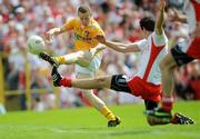 19 July 2009; Paddy Cunningham, Antrim, has a shot on goal despite the attentions of Justin McMahon, Tyrone. GAA Football Ulster Senior Championship Final, Tyrone v Antrim, St Tighearnach's Park, Clones, Co. Monaghan. Picture credit: Brian Lawless / SPORTSFILE