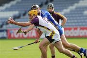 25 July 2009; David Redmond, Wexford, in action against Tony Griffin, Clare. GAA Hurling All-Ireland Senior Championship Relegation, Round 1, Clare v Wexford, O'Moore Park, Portlaoise, Co. Laois. Picture credit: Matt Browne / SPORTSFILE