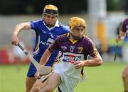 25 July 2009; David Redmond, Wexford, in action against Tony Griffin, Clare. GAA Hurling All-Ireland Senior Championship Relegation, Round 1, Clare v Wexford, O'Moore Park, Portlaoise, Co. Laois. Picture credit: Matt Browne / SPORTSFILE