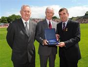 19 July 2009; Uachtarán Chumann Lúthchleas Gael Criostóir Ó Cuana, left, and Ulster GAA President Tom Daly, right, present Jim McKeever, Derry, with a special 125 Celebrations momento of All Ireland Captains before the GAA Football Ulster Senior Championship Final, Tyrone v Antrim, St Tighearnach's Park, Clones, Co. Monaghan. Picture credit: Oliver McVeigh / SPORTSFILE