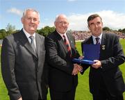 19 July 2009; Uachtarán Chumann Lúthchleas Gael Criostóir Ó Cuana, left, and Ulster GAA President Tom Daly, right, present Sean O'Neill, Down, with a special 125 Celebrations momento of All Ireland Captains before the GAA Football Ulster Senior Championship Final, Tyrone v Antrim, St Tighearnach's Park, Clones, Co. Monaghan. Picture credit: Oliver McVeigh / SPORTSFILE