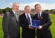 19 July 2009; Uachtarán Chumann Lúthchleas Gael Criostóir Ó Cuana, left, and Ulster GAA President, Tom Daly, right, present Martin McHugh, Donegal, representing Anthony Molloy, with a special 125 Celebrations momento of All Ireland Captains before the GAA Football Ulster Senior Championship Final, Tyrone v Antrim, St Tighearnach's Park, Clones, Co. Monaghan. Picture credit: Oliver McVeigh / SPORTSFILE