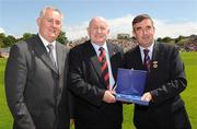 19 July 2009; Uachtarán Chumann Lúthchleas Gael Criostóir Ó Cuana, left, and Ulster GAA President Tom Daly, right, present Paddy Doherty, Down, with a special 125 Celebrations momento of All Ireland Captains before the GAA Football Ulster Senior Championship Final, Tyrone v Antrim, St Tighearnach's Park, Clones, Co. Monaghan. Picture credit: Oliver McVeigh / SPORTSFILE