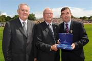 19 July 2009; Uachtarán Chumann Lúthchleas Gael Criostóir Ó Cuana, left, and Ulster GAA President, Tom Daly, right, present Kevin Mussen, Down, with a special 125 Celebrations momento of All Ireland Captains before the GAA Football Ulster Senior Championship Final, Tyrone v Antrim, St Tighearnach's Park, Clones, Co. Monaghan. Picture credit: Oliver McVeigh / SPORTSFILE