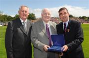 19 July 2009; Uachtarán Chumann Lúthchleas Gael Criostóir Ó Cuana, left, and Ulster GAA President Tom Daly, right, present Tommy Hall, Antrim, with a special 125 Celebrations momento of All Ireland Captains before the GAA Football Ulster Senior Championship Final, Tyrone v Antrim, St Tighearnach's Park, Clones, Co. Monaghan. Picture credit: Oliver McVeigh / SPORTSFILE