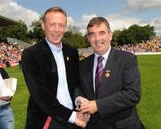 19 July 2009; Tyrone 1984 Jubilee Team member Eugene McKenna receives a presentation from Ulster GAA President Tom Daly, right, at half time in the GAA Football Ulster Senior Championship Final, Tyrone v Antrim, St Tighearnach's Park, Clones, Co. Monaghan. Picture credit: Oliver McVeigh / SPORTSFILE