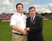 19 July 2009;Tyrone 1984 Jubilee Team member Colm Donaghy receives a presentation from Ulster GAA President Tom Daly, right, at half time in the GAA Football Ulster Senior Championship Final, Tyrone v Antrim, St Tighearnach's Park, Clones, Co. Monaghan. Picture credit: Oliver McVeigh / SPORTSFILE