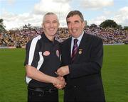 19 July 2009; Tyrone 1984 Jubilee Team member Eugene Mullan receives a presentation from Ulster GAA President Tom Daly, right, at half time in the GAA Football Ulster Senior Championship Final, Tyrone v Antrim, St Tighearnach's Park, Clones, Co. Monaghan. Picture credit: Oliver McVeigh / SPORTSFILE