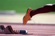 22 September 2000; A general view of golden track spikes worn by Michael Johnson of USA as he leaves the starting blocks in the men's 400m at Stadium Australia in Sydney Olympic Park, Homebush Bay, Sydney, Australia.  Photo by Brendan Moran/Sportsfile