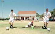 27 January 1999; Dave Warren, left and Joe Murphy pass the local groundsman at work during a Republic of Ireland U-17 Squad Training Session at Greenpoint AFC in Capetown, South Africa. Photo by David Maher/Sportsfile