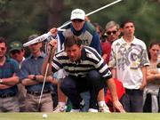 5 July 1997; Nick Faldo of England studies a putt on the first green with the help of his caddy Fanny Senesen during the third round of the Murphy's Irish Open Golf Championship at Druid's Glen Golf Course in Wicklow. Photo by David Maher/Sportsfile