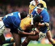 6 November 1999; Stephen Larkham of Australia in action against Raphael Ibanez, left, and Abdelatif Benazzi of France during the Rugby World Cup Final match between Australia and France at the Millenium Stadium in Cardiff, Wales. Photo by Brendan Moran/Sportsfile