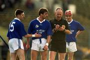 26 November 2000; Referee Ger Harrington books Tony Browne of Mount Sion, second from left, during the AIB Munster Senior Hurling Club Championship Final match between Sixmilebridge and Mount Sion at Semple Stadium in Thurles, Tipperary.  Photo By Brendan Moran/Sportsfile