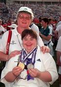 4 July 1999; Special Olympian Denise Fegan, Lenaderg, Down who won Gold and Silver medals in Athletics pictured with Athletics coach Liz Henry at the Closing Ceremony of the 1999 Special Olympics World Summer Games in Raleigh, North Carolina. Photo by Ray McManus/Sportsfile