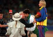 25 September 2000; Sonia O'Sullivan of Ireland is presented with her silver medal by Pat Hickey, President of the Olympic Council of Ireland, alongside gold medallist, Gabriela Szabo of Romania, during the medal ceremony following the Women's 5000m Final at Stadium Australia in Sydney Olympic Park, Homebush Bay, Sydney, Australia.  Photo by Brendan Moran/Sportsfile