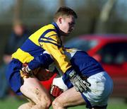 14 January 2001; Paul Dunne of Laois is tackled by Enda Ledwith of Longford during the O'Byrne Cup First Round match between Longford and Laois at Pearse Park in Longford. Photo by Aoife Rice/Sportsfile