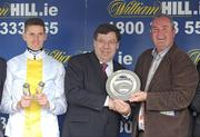 29 July 2009; An Taoiseach Brian Cowen T.D. presents owner of Ballyholland Cathal McGovern with the Galway Plate in the company of jockey Andrew McNamara after the William Hill Galway Plate. Galway Racing Festival - Wednesday, Ballybrit, Galway. Picture credit: Stephen McCarthy / SPORTSFILE