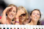 30 July 2009; Sinead Kennelly, Eilish and Sinead Rattigan, from Dunmore, Co. Galway, watch on during the racing. Galway Racing Festival - Thursday, Ballybrit, Galway. Picture credit: Stephen McCarthy / SPORTSFILE