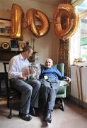 31 July 2009; Martin White, the oldest All-Ireland hurling medal winner still alive, was joined for his 100th birthday celebrations by Kilkenny's Tommy Walsh, holding the Liam MacCarthy cup, at his Dublin home in Glasnevin. Martin won Senior All-Ireland hurling medals with Kilkenny in 1932, 1933 & 1935. Picture credit: David Maher / SPORTSFILE