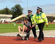 1 August 2009; Martin Fagan, Mullingar Harriers A.C., is taken from the track by members of the St. John's Ambulance. Woodie's DIY / AAI National Senior Track & Field Championships - Saturday. Morton Stadium, Santry, Dublin. Picture credit: Stephen McCarthy / SPORTSFILE