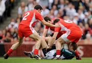 2 August 2009; Alan Smith, Kildare, is surrounded by Tyrone defenders P.J. Quinn, left, Justin McMahon and Conor Gormley, right. GAA Football All-Ireland Senior Championship Quarter-Final, Tyrone v Kildare, Croke Park, Dublin. Picture credit: Ray McManus / SPORTSFILE