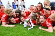 2 August 2009; Cork players dive on captain Maureen O'Sullivan, with the cup, after defeating Mayo. All-Ireland Minor A Championship Final, Cork v Mayo, Wolfe Tones GAA Club, Shannon, Co. Clare. Picture credit: Kieran Clancy / SPORTSFILE