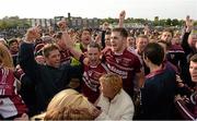 27 September 2015;  Ruairi Og Cushendall players celebrating with fans after the game. Antrim Senior Championship Hurling Final, Ruairi Og Cushendall v Ballycastle McQuillan, Dunloy GAA Club, Dunloy, Co. Antrim. Picture credit: Oliver McVeigh / SPORTSFILE