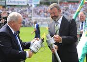 12 July 2009; Liam Lenihan, right, Chairman of the Limerick County Board, has his torch lit by Jimmy O'Gorman, Chairman of the Munster Council, during the pre-match celebrations. GAA Hurling Munster Senior Championship Final, Tipperary v Waterford, Semple Stadium, Thurles, Co. Tipperary. Picture credit: Brendan Moran / SPORTSFILE