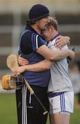 4 July 2015;    A shoulder to lean on. Laois manager Séamus Plunkett consoles corner back Brian Stapleton after they crash out against Dublin.    Picture credit: Dáire Brennan / SPORTSFILE    This image may be reproduced free of charge when used in conjunction with a review of the book &quot;A Season of Sundays 2015&quot;. All other usage © SPORTSFILE