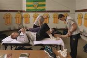 27 June 2015;    A bit of light reading. Donegal midfielder Neil Gallagher studies the match programme while on the treatment table before his team's successful Clones test against Derry.    Picture credit: Oliver McVeigh / SPORTSFILE    This image may be reproduced free of charge when used in conjunction with a review of the book &quot;A Season of Sundays 2015&quot;. All other usage © SPORTSFILE