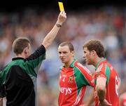 9 August 2009; Referee Joe McQuillan issues a yellow card to Mayo's Trevor Howley as Keith Higgins, 4, looks on. GAA Football All-Ireland Senior Championship Quarter-Final, Meath v Mayo, Croke Park, Dublin. Picture credit: Ray McManus / SPORTSFILE