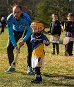 21 November 2015; Dublin's Daire Plunkett with local child Darragh Nugent, age three years, during a coaching session. Darragh's mother Karren is from Lousiburgh , Co Mayo. Irish Cultural Centre, New Boston Dr, Canton, MA, USA. Picture credit: Ray McManus / SPORTSFILE