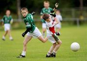 16 August 2009; Dean McKenna, Termonmaguirc, Co. Tyrone, in action against David Wrynne, Ballinamore, Co. Leitrim, during the Gaelic Football Mixed Under 10's Final. HSE Community Games National Finals, Institute of Technology, Athlone, Co. Westmeath. Photo by Sportsfile