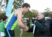 22 November 2015; Jim Dowdall, CEO of GloHealth, awards John Coghlan, Metro St. Brigids A.C., with his medal after finishing second in the Senior Men's event. GloHealth National Cross Country Championships, Santry Demesne, Dublin. Picture credit: Cody Glenn / SPORTSFILE