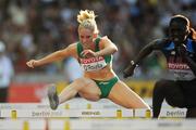 19 August 2009; Ireland's Derval O'Rourke on her way to finishing 3rd in her semi-final of the Women's 100m Hurdles behind Dawn Harper of the USA and qualifying for the final in a season best time of 12.37 sec. 12th IAAF World Championships in Athletics, Olympic Stadium, Berlin, Germany. Picture credit: Brendan Moran  / SPORTSFILE