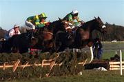28 December 1999; Oa Baldixe, with Paul Carberry up, left, and Raunchy, with Charlie Swan up, jumps the hurdle during The O'Dwyers Stillorgan Orchard Novice Hurdle at Leopardstown Racecourse in Dublin. Photo by Matt Browne/Sportsfile