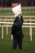 26 December 2000; A racecourse official raises the white flag during day one of the Christmas Festival at Leopardstown Racecourse in Dublin. Photo by Ray McManus/Sportsfile