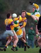28 January 2001; Ciaran McManus of Offaly is tackled by Michael Mahon, left, Iain Wickham of Wexford during the O'Byrne Cup Semi-Final match between Wexford and Offaly at the Gaelic Grounds in Bunclody, Wexford. Photo by Aoife Rice/Sportsfile