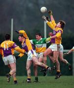 28 January 2001; Iain Wickham of Wexford goes up for the ball against Mark Daly and Ciaran McManus of Offaly during the O'Byrne Cup Semi-Final match between Wexford and Offaly at the Gaelic Grounds in Bunclody, Wexford. Photo by Aoife Rice/Sportsfile