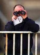 28 January 2001; A racegoer watches racing with his binoculars at Fairyhouse Racecourse in Ratoath, Meath. Photo by Damien Eagers/Sportsfile