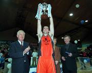 28 January 2001; Killester's John Leahy celebrates with the ESB cup, in the company of President Mary McAleese, Finn Ahern, President of IBA, and Ted Dalton of ESB following the ESB Men's Cup Final match between Killester and Longnecks Ballina at the National Basketball Arena in Tallaght, Dublin. Photo by Brendan Moran/Sportsfile